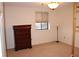 Empty bedroom with carpeted floors, a window, and a dresser at 300 Johnson Ferry Rd # B802, Atlanta, GA 30328