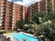 Apartment building exterior with a pool and lush landscaping at 300 Johnson Ferry Rd # B802, Atlanta, GA 30328