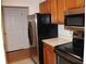 Kitchen with stainless steel appliances, wood cabinetry, and tile floor at 300 Johnson Ferry Rd # B802, Atlanta, GA 30328