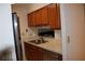 Kitchen with wood cabinets, stainless steel appliances, and double sink at 300 Johnson Ferry Rd # B802, Atlanta, GA 30328