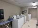 Laundry room with washers, dryers, ironing board, and change machine at 300 Johnson Ferry Rd # B802, Atlanta, GA 30328