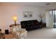 Living area with leather sofa, patterned chair, and balcony access at 300 Johnson Ferry Rd # B802, Atlanta, GA 30328