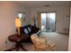 Living room with leather couch, floral chair, and balcony access at 300 Johnson Ferry Rd # B802, Atlanta, GA 30328