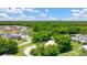 Aerial view of houses, trees, and a riding arena at 8598 Secretariat Dr, Lithonia, GA 30058