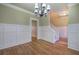 Formal dining room with hardwood floors, wainscoting, and a chandelier at 1081 Bridgemill Ave, Canton, GA 30114