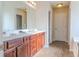 Double vanity bathroom with dark wood cabinets and a marble countertop at 104 Cessna Dr, Canton, GA 30114