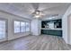 Finished basement recreation room, built-in shelving, and hardwood floors at 2075 Pine Tree Dr # A4, Buford, GA 30518