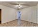 Spacious basement room with wood-look flooring and ceiling fan at 2075 Pine Tree Dr # A4, Buford, GA 30518