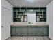 Basement wet bar with dark green cabinets and tile counter at 2075 Pine Tree Dr # A4, Buford, GA 30518
