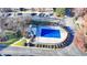Community pool with covered enclosure, surrounded by landscaping at 2075 Pine Tree Dr # A4, Buford, GA 30518