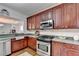 Updated kitchen with stainless steel appliances and wood cabinets at 2075 Pine Tree Dr # A4, Buford, GA 30518
