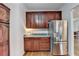 Kitchen with stainless steel refrigerator and wood cabinets at 2075 Pine Tree Dr # A4, Buford, GA 30518