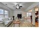Open living room with hardwood floors, fireplace, and view to dining area at 2075 Pine Tree Dr # A4, Buford, GA 30518