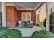 Cozy covered patio with brick flooring and comfortable seating at 2075 Pine Tree Dr # A4, Buford, GA 30518