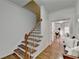 Hardwood staircase with white railings leading to upper level at 2075 Pine Tree Dr # A4, Buford, GA 30518
