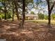 Brick ranch house nestled among trees, showcasing a large backyard at 3550 Bay Creek Church Rd, Loganville, GA 30052