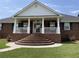 Brick stairs and porch with white columns leading to the entrance at 3550 Bay Creek Church Rd, Loganville, GA 30052