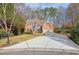 Two-story house with a large driveway and mature trees at 12175 Clairmeade Trl, Alpharetta, GA 30009