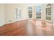 Sunroom with hardwood floors and expansive windows at 12175 Clairmeade Trl, Alpharetta, GA 30009