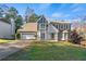 Two-story house with gray siding, white garage doors, and a landscaped lawn at 1514 Yorktown Dr, Lawrenceville, GA 30043