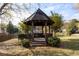 Wooden gazebo near a lake with views of houses and trees at 2601 Vineyard Se Way, Smyrna, GA 30082