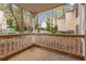 Covered patio with white railing, overlooking a wooded area with cars parked beyond at 2601 Vineyard Se Way, Smyrna, GA 30082