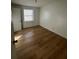 Simple bedroom with light wood-look flooring and a window at 1777 Cahoon Sw St, Atlanta, GA 30310