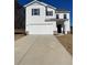 Two-story house with white siding, brown accents, and a two-car garage at 7522 Saffron Ave, Covington, GA 30014