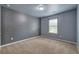 Bedroom with gray plank accent wall and neutral carpet at 138 Gorham Gates Dr, Hiram, GA 30141