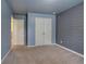 Bedroom with double doors and gray plank accent wall at 138 Gorham Gates Dr, Hiram, GA 30141