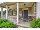 Covered porch with white columns, stone base, and a dark gray front door at 138 Gorham Gates Dr, Hiram, GA 30141