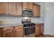 Well-equipped kitchen with stainless steel appliances and wood cabinets at 138 Gorham Gates Dr, Hiram, GA 30141