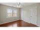 Bedroom with hardwood floors, large window, and double closets at 2034 Tyler Trce, Lawrenceville, GA 30043