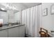 Clean bathroom with granite countertop, white cabinets, and a shower/tub combo at 390 17Th Nw St # 3055, Atlanta, GA 30363