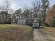 Brick ranch home with a driveway and mature trees at 5910 Lakeshore Se Dr, Mableton, GA 30126