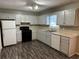 Bright eat-in kitchen with updated appliances and wood-look flooring at 3506 Ten Oaks Ct, Powder Springs, GA 30127
