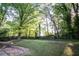 Large backyard with lush trees and privacy fence at 1639 Northlake Springs Ct, Decatur, GA 30033