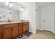 Double vanity bathroom with granite countertop and large mirror at 2599 Windsor Knoll Dr, Dacula, GA 30019