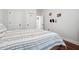 Simple bedroom with striped bedding and wood floors at 2599 Windsor Knoll Dr, Dacula, GA 30019