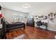Bright bedroom featuring hardwood floors, a bed, and a workspace at 2599 Windsor Knoll Dr, Dacula, GA 30019
