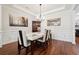 Formal dining room with hardwood floors, chandelier, and white table at 2599 Windsor Knoll Dr, Dacula, GA 30019