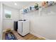Laundry room with washer, dryer, and shelving at 2599 Windsor Knoll Dr, Dacula, GA 30019