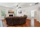 Spacious living room with a curved sectional sofa, hardwood floors and a fireplace at 2599 Windsor Knoll Dr, Dacula, GA 30019