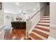 Elegant staircase with white railings and hardwood treads leading to the upper level at 2599 Windsor Knoll Dr, Dacula, GA 30019