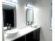 Double vanity bathroom with modern fixtures and mirrors at 1445 Watercrest Cir, Lawrenceville, GA 30043