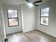 Well-lit bedroom with hardwood floors and two windows at 1445 Watercrest Cir, Lawrenceville, GA 30043