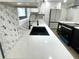 Sleek kitchen with a quartz countertop and black farmhouse sink at 1445 Watercrest Cir, Lawrenceville, GA 30043
