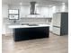 Modern kitchen with white cabinets, a large island, and stainless steel appliances at 1445 Watercrest Cir, Lawrenceville, GA 30043