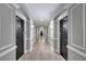 Elegant hallway with gray walls, hardwood floors, and black doors at 1850 Cotillion Dr # 2304, Atlanta, GA 30338