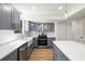 Modern kitchen with gray cabinets, white countertops, and stainless steel appliances at 9106 Kelly Ct, Jonesboro, GA 30236